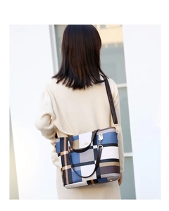 Detailed view of the large plaid tote bag showing its back-worn style on a model