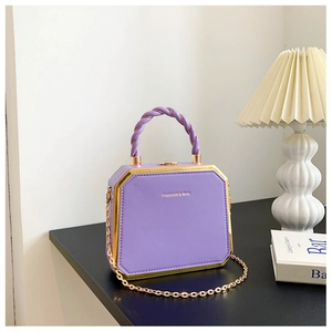 Purple hexagonal hard shell chain bag with gold metal trim and woven handle
