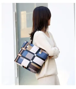 Detail of plaid tote bag with metal chain link and luxury blue white leather texture
