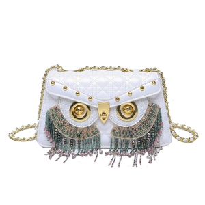 Quilted white owl crossbody bag with gold rivets and colorful beaded tassels detail