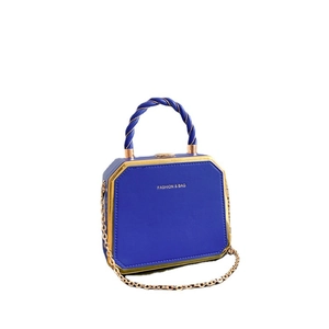 Blue octagonal hardshell handbag with gold metal trim and detachable chain strap