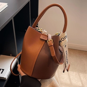 Brown leather color-block bucket bag with handle and adjustable shoulder strap