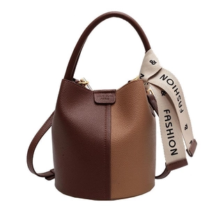 Two-tone bucket bag in dark brown and tan leather with decorative fashion scarf
