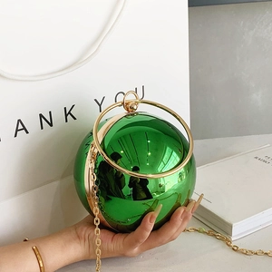 Modern green metallic sphere clutch bag with golden ring handle and chain strap