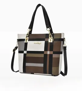 Close-up of large capacity tote bag with contrast plaid pattern and gold logo
