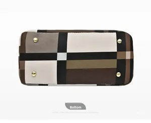 Detailed bottom view of checkered shoulder bag with four protective gold metal feet studs