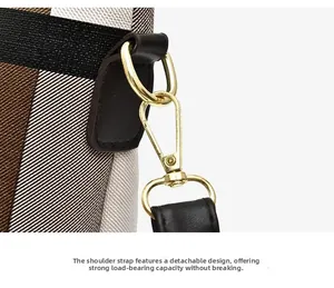 Detailed close-up of golden metal hook and D-ring on classic plaid crossbody bag