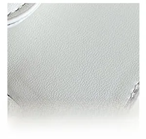 Détail macro de cuir synthétique blanc à grain litchi avec finitions cousues