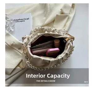 Internal view of the pleated cloud bag showing storage space for wallet and cosmetics