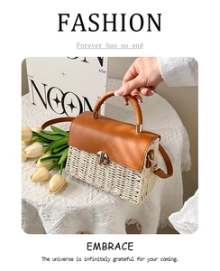 Close-up of woven texture with brown leather flap and round handle on a chic crossbody bag