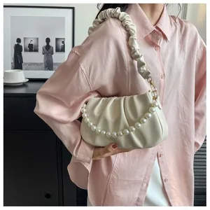 Detail of off-white ruched cloud bag featuring pearl chain and soft leather texture