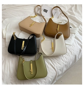 Detail of five moon-shaped armpit bags in various colors with golden piston locks