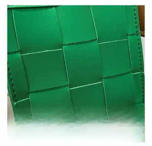 Close-up of vibrant green woven leather texture on a high-quality designer style handbag