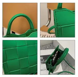 Detail view of woven green handbag showing leather texture, handle and internal space