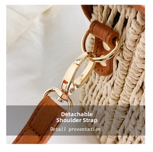 Detail of the golden detachable strap buckle on a minimalist woven straw shoulder bag