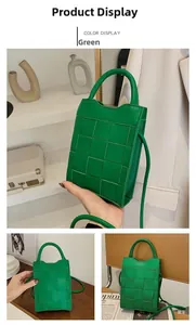 Detail of green woven phone bag with large grid leather texture and slim strap