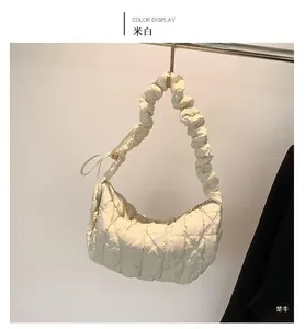 Detail of cream white quilted puffy cloud bag with scrunchie shoulder strap design