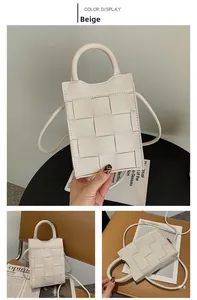 Detail of beige woven mini crossbody bag with leather texture and top handle