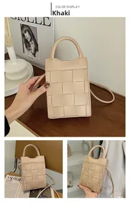 Detail of woven khaki mini phone bag with wide cross-stitch texture and leather handles