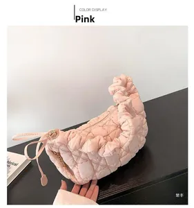 Macro shot of pink quilted cloud bag featuring nylon fabric texture and zip closure