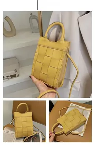 Detail of yellow woven mini crossbody bag with large grid pattern and top handle