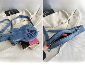 Detail of violin-shaped denim bag showing zipper opening and interior storage capacity