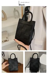 Detail of black woven mini handbag featuring a premium checkerboard texture and handle