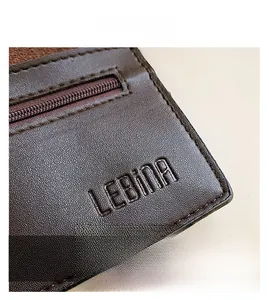 Macro shot of dark brown litchi grain leather texture with LEBINA embossed logo