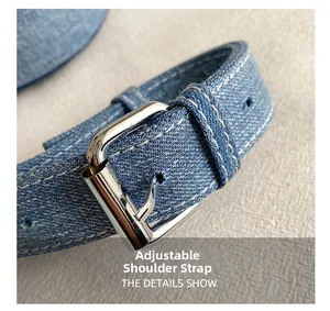 Detail showing blue denim adjustable shoulder strap with silver buckle and white stitching