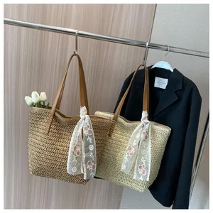 Macro view of woven straw tote bag with retro rose embroidery lace scarf detail