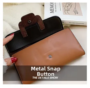 Detail view of the brown leather wallet featuring a durable metal snap button closure