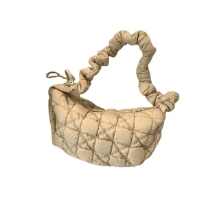 Chic beige quilted puffer shoulder bag with ruched handles in minimalist cloud style