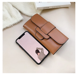 Brown leather long wallet for women with flap closure and elegant wide buckle detail