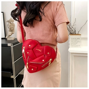 Detail of red heart-shaped jacket bag with gold zippers and motorcycle-style collar