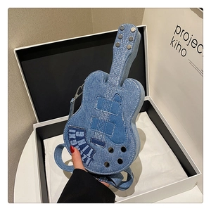 Detail view of denim guitar shoulder bag with metallic tuning knobs and stitched patchwork
