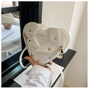 Detail of white heart-shaped biker bag featuring silver zippers and metallic AYWG logo
