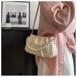 Detail of off-white ruched cloud bag with pearl chain and soft leather texture