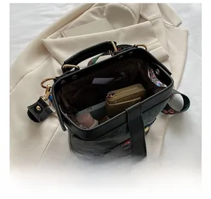 Vue détaillée du compartiment intérieur spacieux du sac docteur brodé avec objets