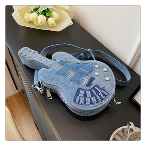 Detail of blue denim guitar-shaped crossbody bag with silver tuning pegs and embroidery