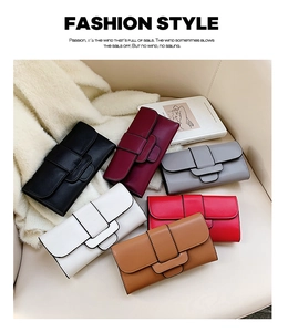 Flat lay of multi-color leather wallets with decorative buckles on a soft chair