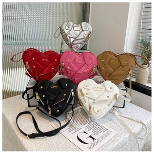 Detailed view of fashionable heart-shaped crossbody bags in various vibrant colors