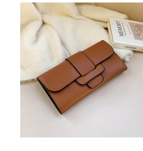 Close-up of brown leather long clutch with unique three-layer flap and matte finish