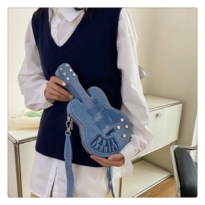 Detail view of denim guitar shaped crossbody bag with metallic rivets and embroidery