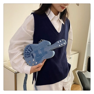 Detail of guitar-shaped denim crossbody bag with stitching and metallic rivet accents