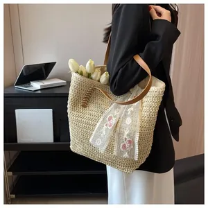 Detailed macro view of woven beige tote bag with floral lace scarf and brown leather handle