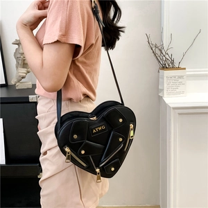 Fashionable black heart-shaped crossbody bag with moto jacket style zippers and rivets