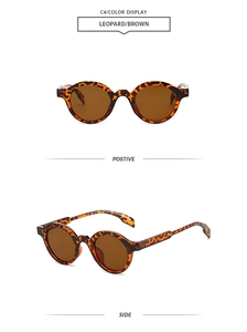 Detail view of retro oval sunglasses with leopard frames and brown lenses