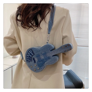 Detail of guitar-shaped denim crossbody bag with ZENGXI TING patch and metal rivets