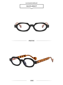 Close-up of black square eyewear with tortoise shell temples and silver metal rivets