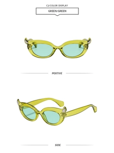 Macro detail of translucent green devil horn sunglasses with silver stud accents